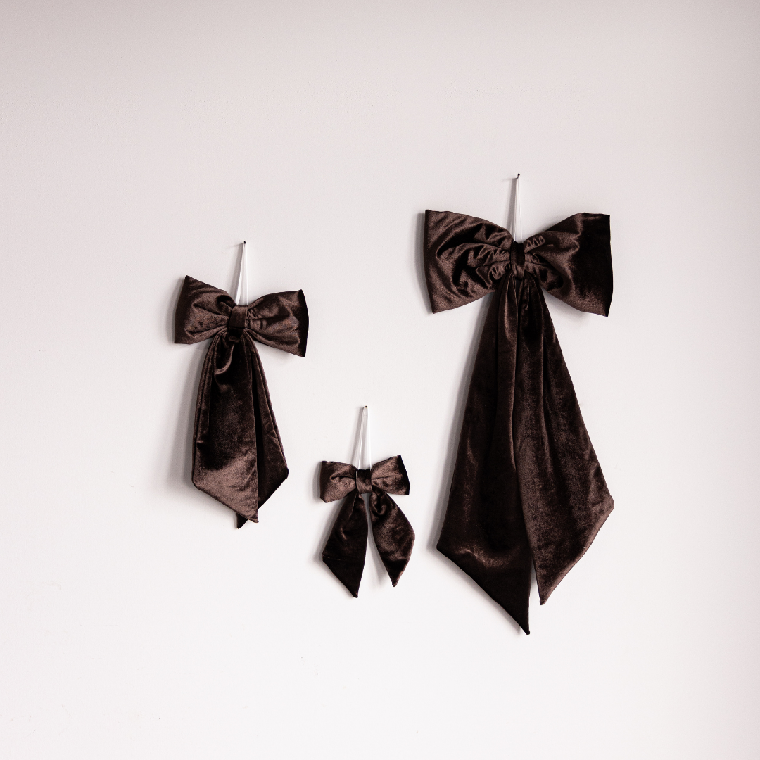 Close-up of brown velvet fabric bow from Luxe B Co, showcasing soft velvet texture and elegant design details.