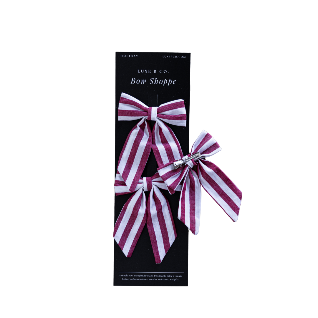 Red and white striped mini fabric bows with clips, festive holiday decor accessories by Luxe B Co, perfect for Christmas decorations.