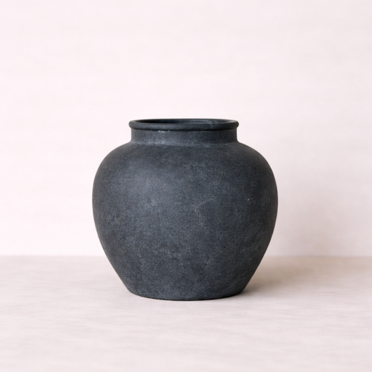 Black ceramic vase on a white background